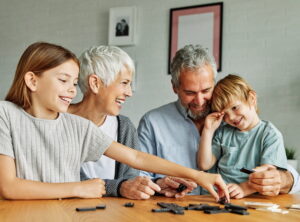 Best Living Annuities in South Africa (Elderly couple playing with grandchildren)