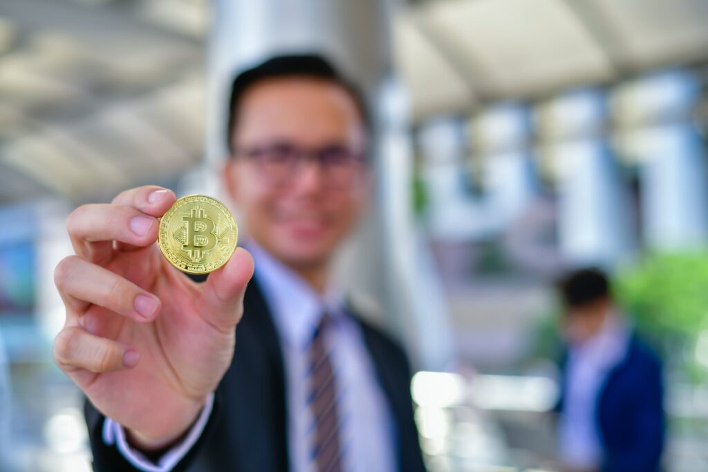 man holding a bitcoin - Everest Wealth