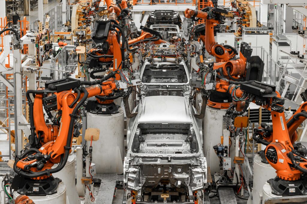 Car assembly line with machines building - Everest Wealth building economic headlines