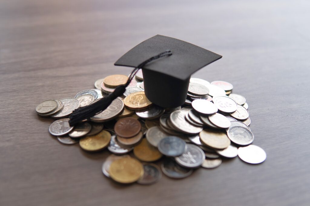 Hat with Coins under it to represent the university policy tensions - Everest Wealth