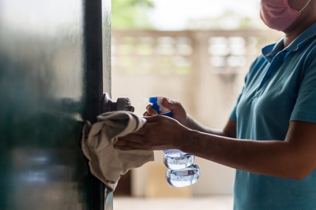 Domestic worker cleaning a door - Everest Wealth