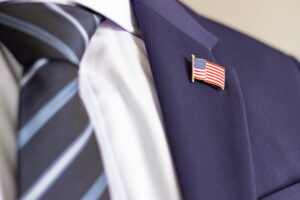 Trump orders U.S. Operation (Man with US flag pin on it)