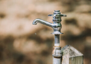 Markets soften as structural pressures tighten across economy (Tap with a single droplet falling out the nossle)