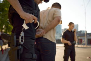 Zero-Tolerance Drink-Driving Law Looms | Everest Wealth (Policeman arresting a drunk driver)