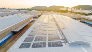 Private Sector Surges Ahead (Solar pannels on a large warehouse roof)