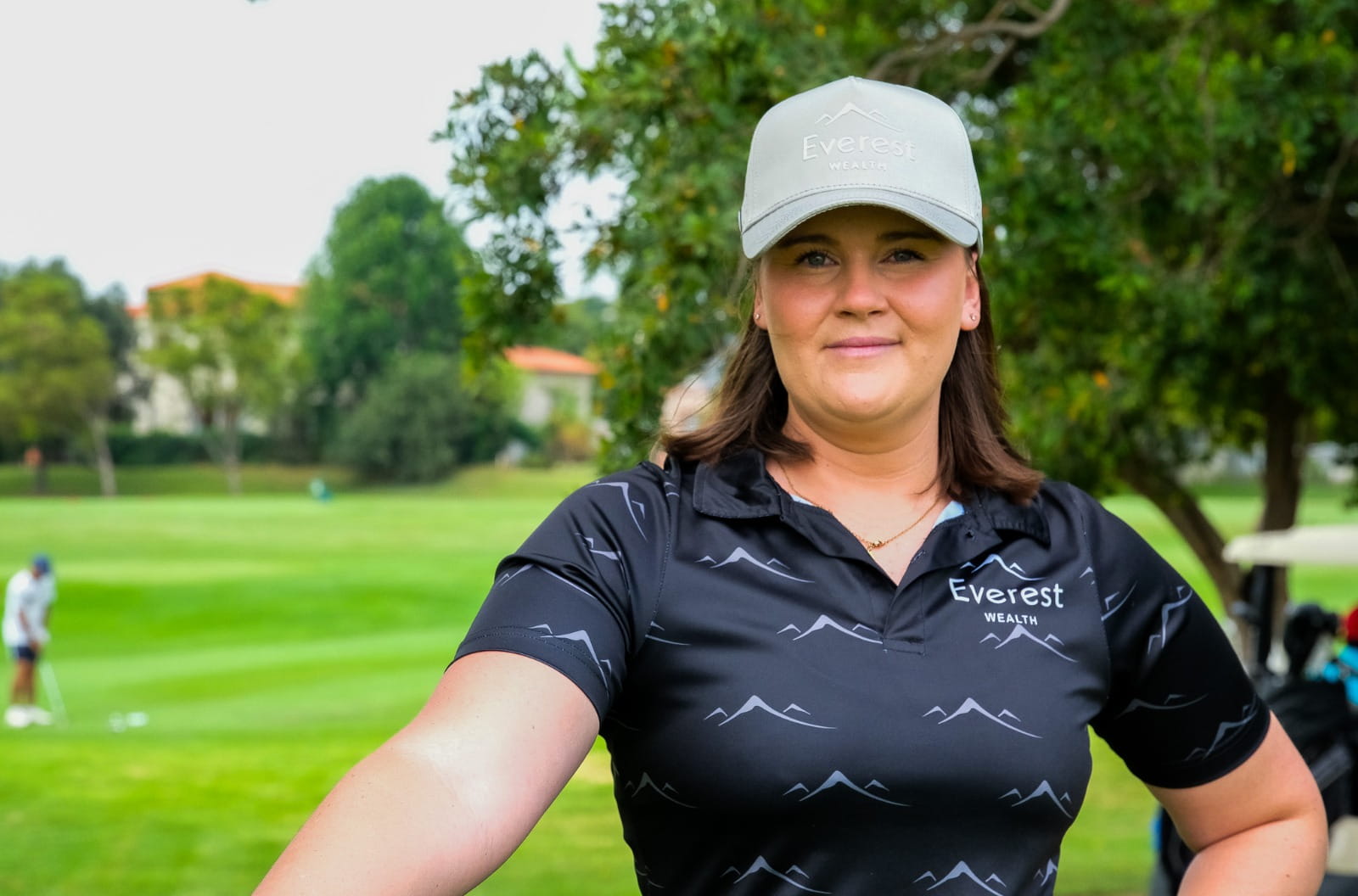 Professional Golfer Shawnelle de Lange wearing black Everest Wealth polo & cap