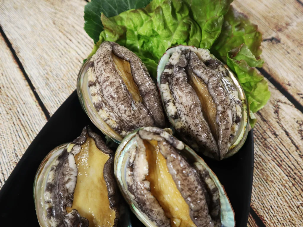 Markets Steady, Energy Legacy Questioned, Crime Syndicates Adapt, and Vehicle Sales Signal Resilience (Abalone on a plate with letuce)