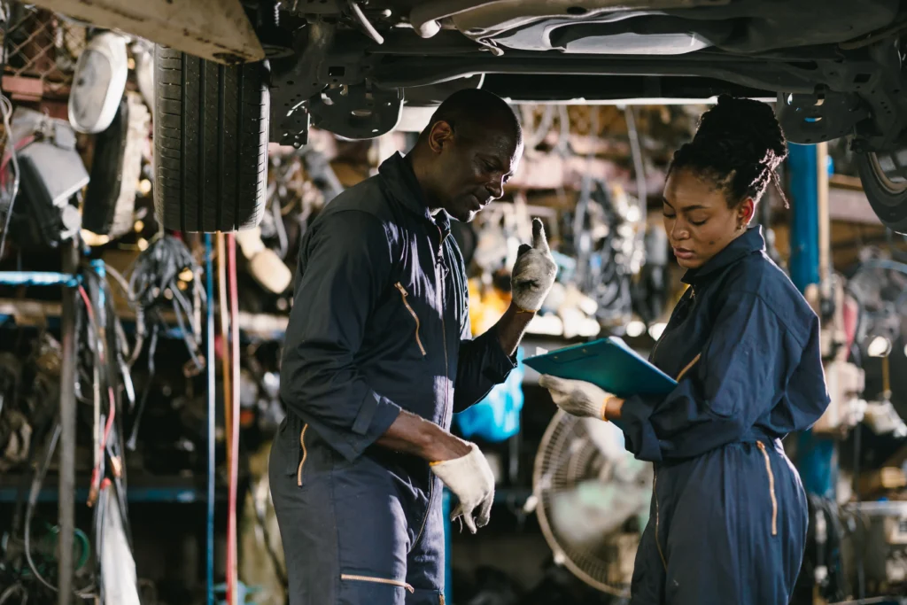 Corruption Concerns Shape Broader Picture (Mechanics working underneath a car)