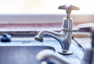 Joburg water crisis boils over (tap with small water drops coming out)