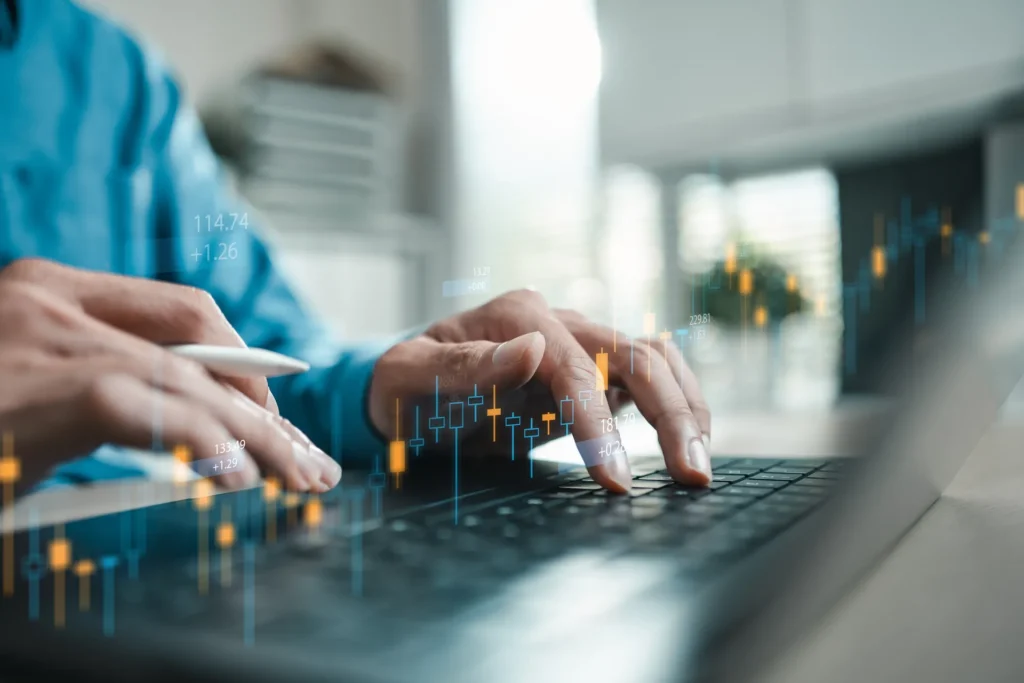 Interest Rate Unchanged: Relief for Now (person using a laptop while holographic statistics hover over their hands)