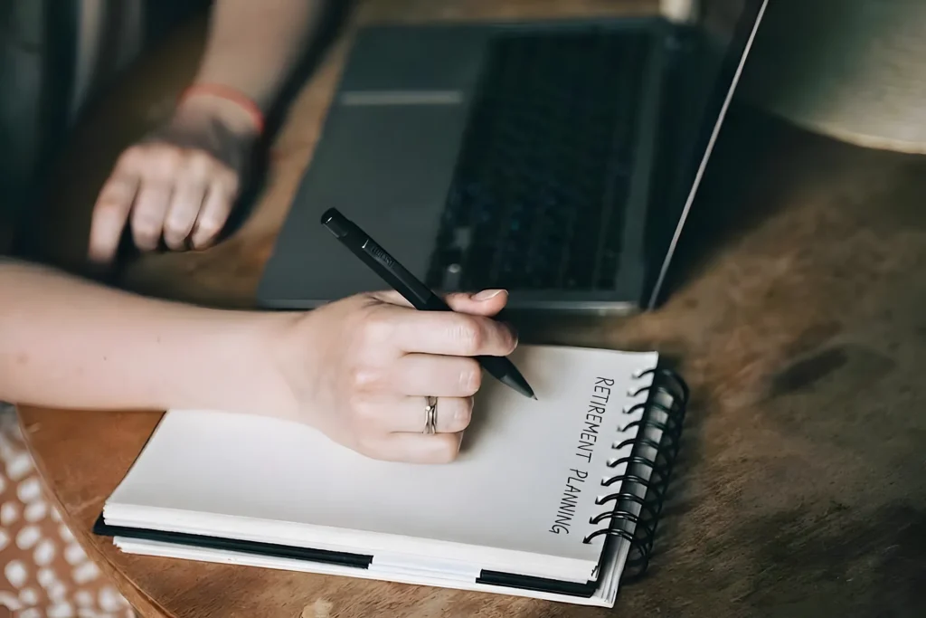 Retire Comfortably in South Africa | Everest Wealth (Person planning retirement on a notepad)