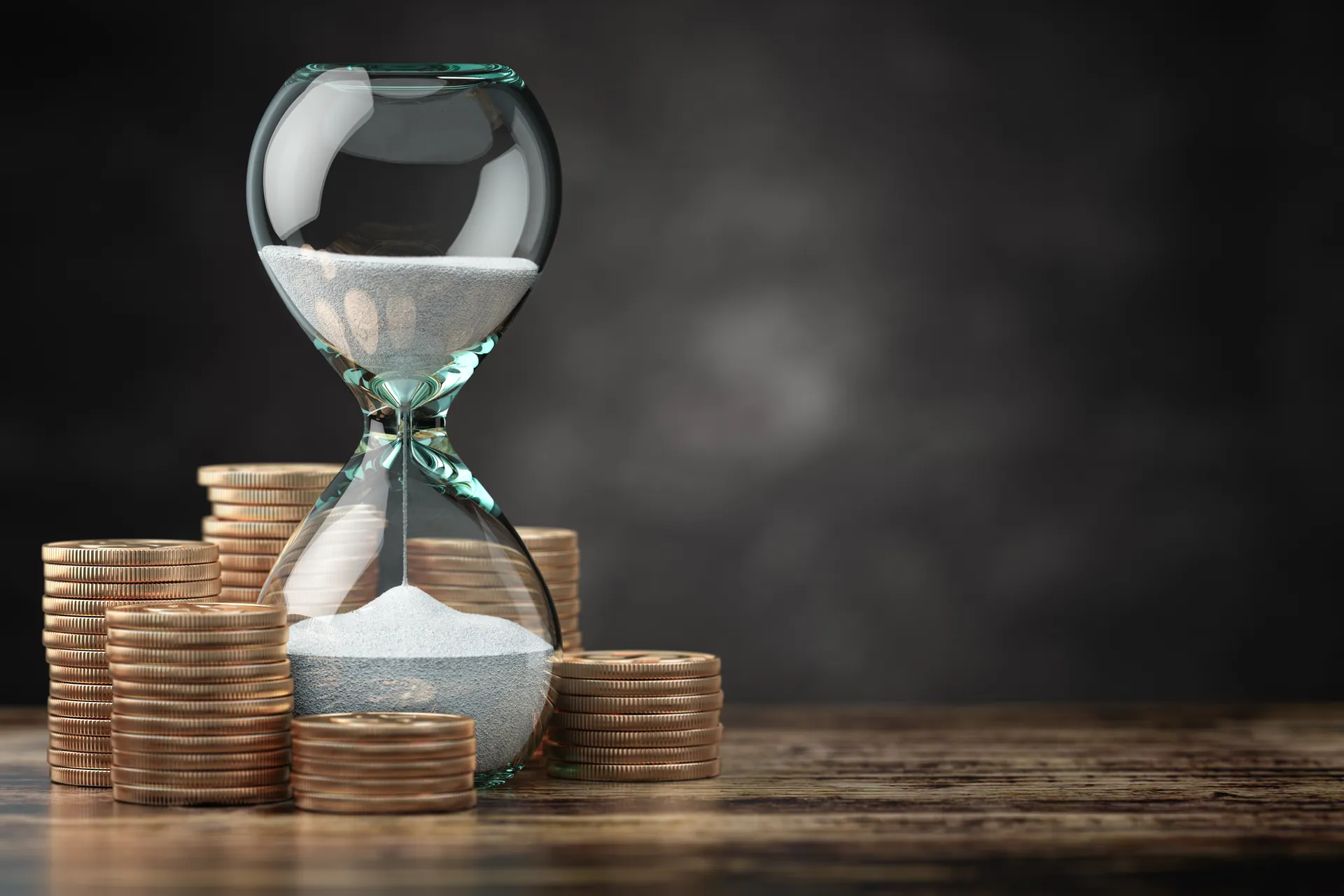 Retire Comfortably in South Africa | Everest Wealth (Hour glass and coins on a desk)
