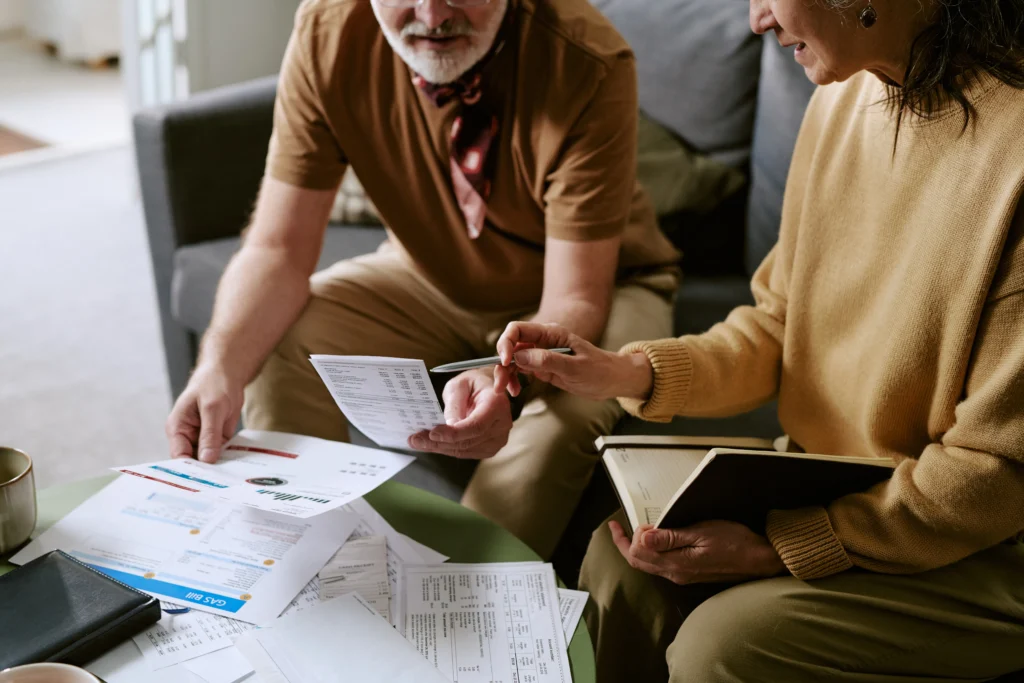Debt and financial pressure in SA (Elderly couple working on financial planning)