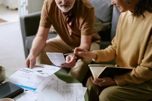 Debt and financial pressure in SA (Elderly couple working on financial planning)