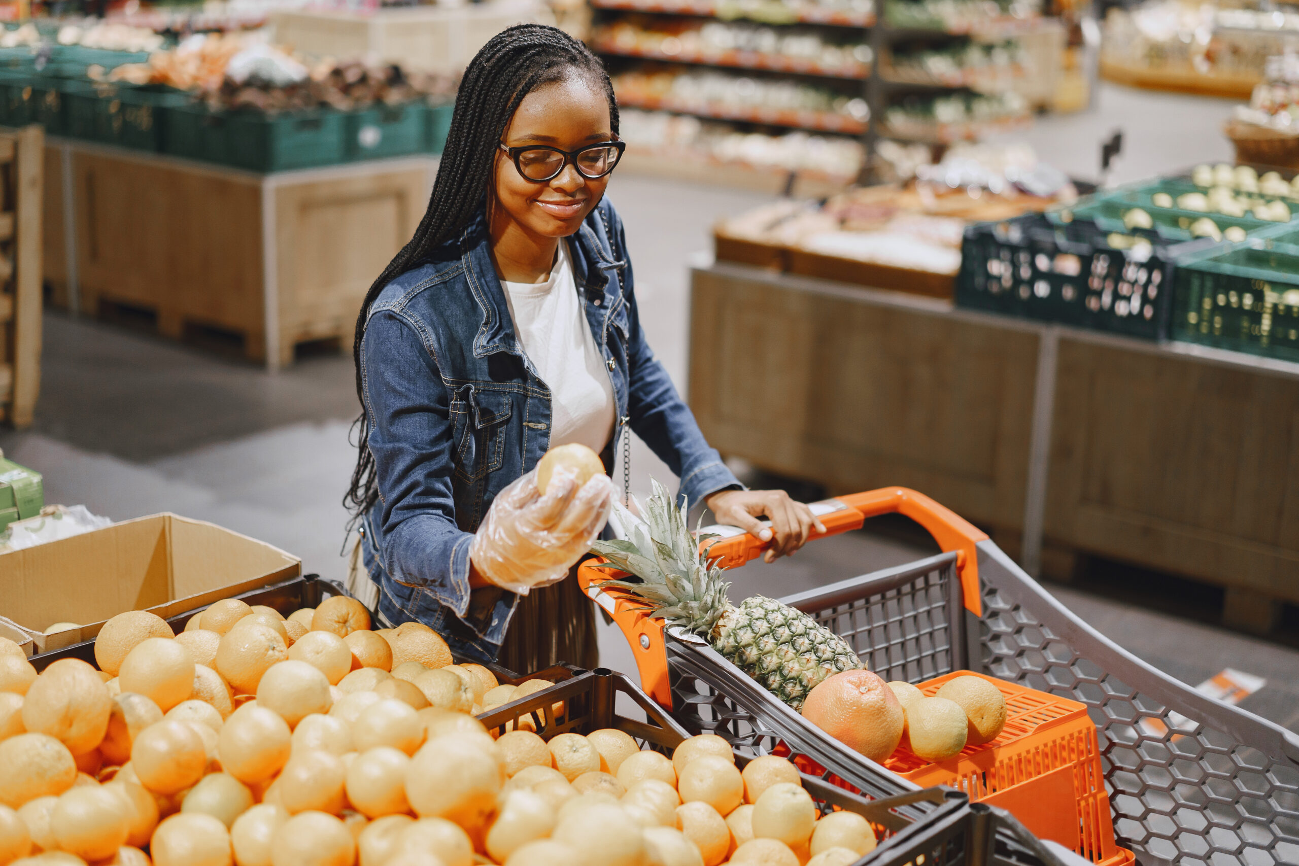 Inflation Brings Relief, Challenges Remain (Woman doing grocery shopping and looking at fresh produce)