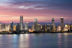 Weaker Growth Outlook Pressures the MTBPS (Cityscape & river at dawn)